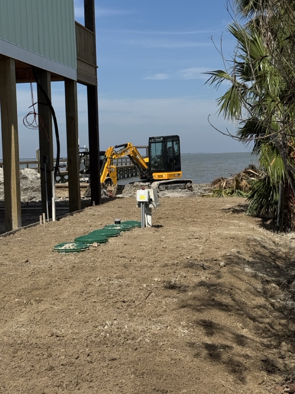 Completed bayfront septic install with risers set and site graded